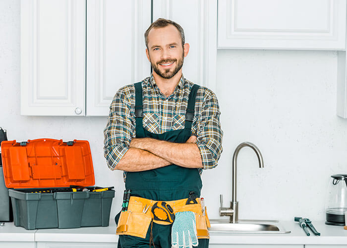 plumber standing with arms crossed